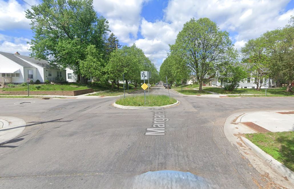 Residential street intersection with traffic circle in the middle to slow traffic