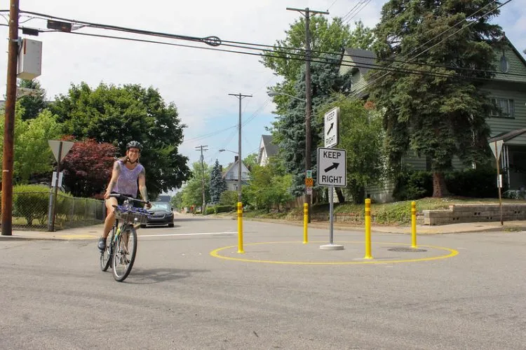 Temporary traffic circle with bollards and paint