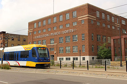 Green Line Train in front of Carleton Lofts