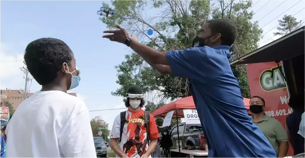 Mayor Carter tosses a drone with students