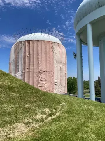 Highland water tower #2 blanketed with large tarps during ongoing work