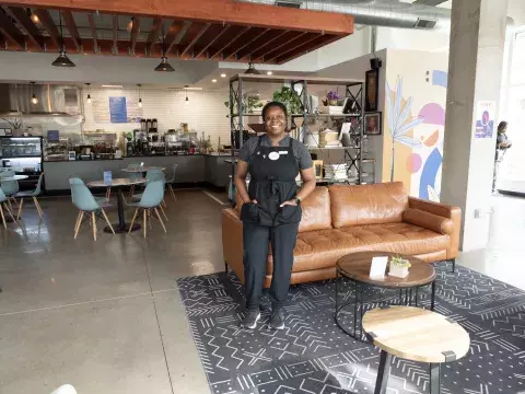 Shaunie Grigsby, owner of Flava Coffee & Cafe poses in her storefront. 