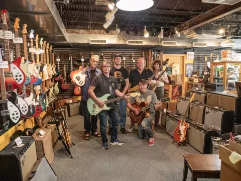 Willie's American Guitars Staff poses with their guitars.