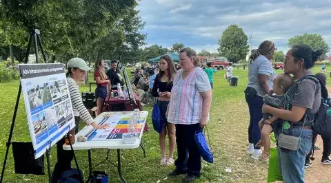 Image of residents at a outdoor community tabling event 