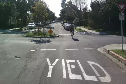 Bike rides down a bike boulevard at a mini roundabout