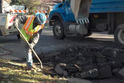 SPRWS crew member shoveling debris out of the street