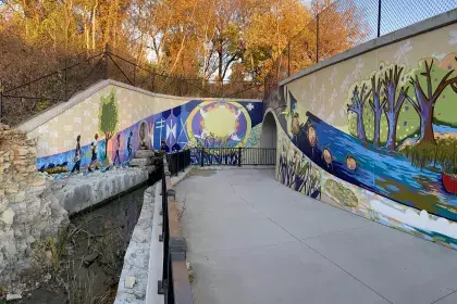 Mural titled “As Above, So Below; Seeing Ourselves in the Creation Story" within Uŋčí Makhá Park 