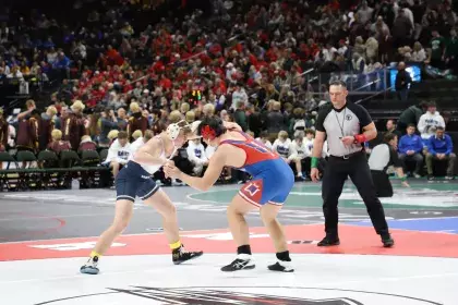 Two boys participating in the MSHSL wrestling tournament at Xcel Energy Center