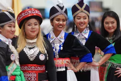 Girls posing for a photo at the Hmong New Year celebration in the Saint Paul RiverCentre